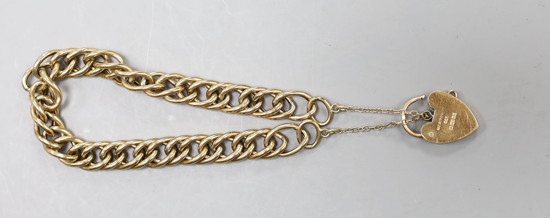 A 9ct gold oval link bracelet, with heart shaped padlock clasp, approximately 18cm
